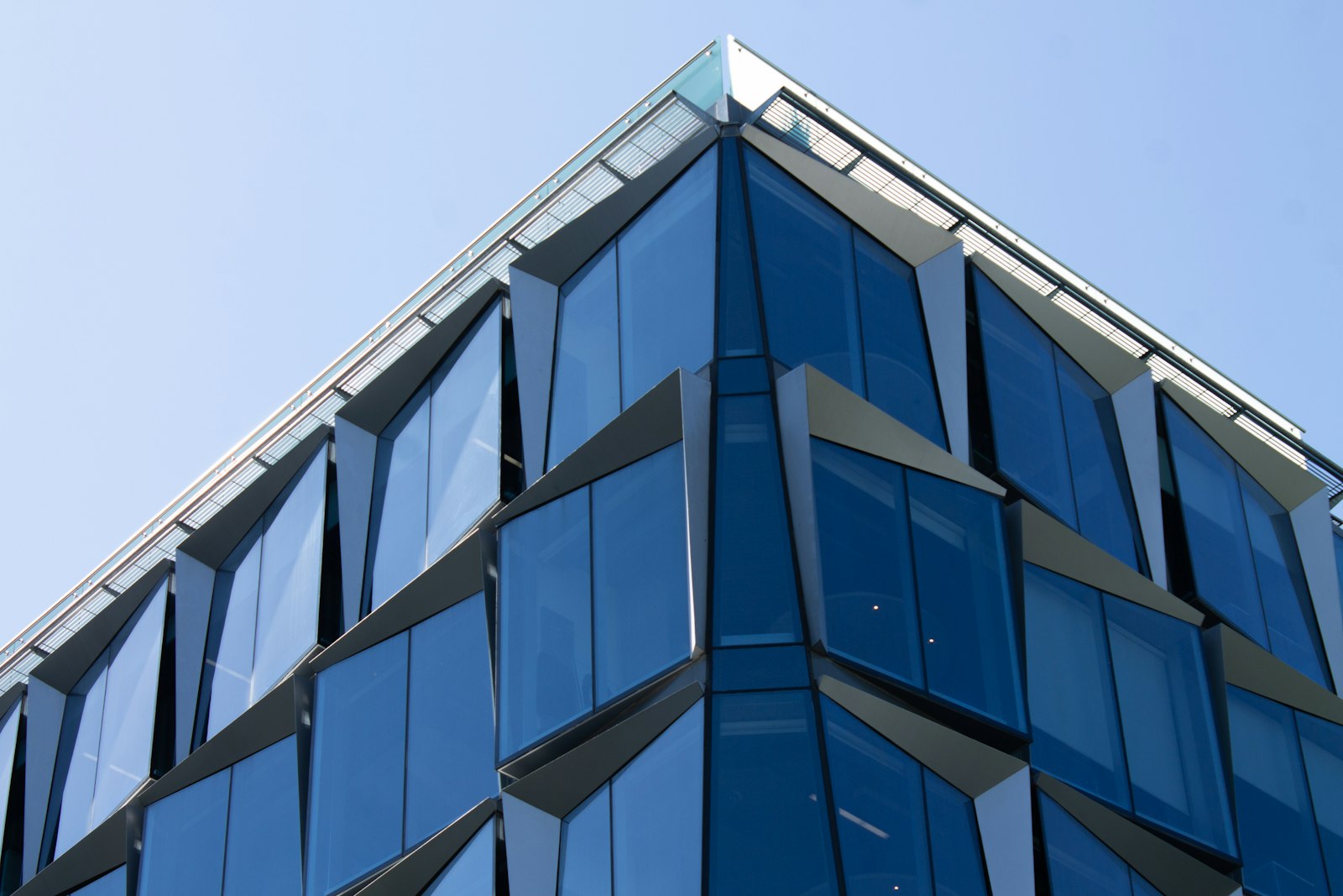 Blue glass office facade from below
