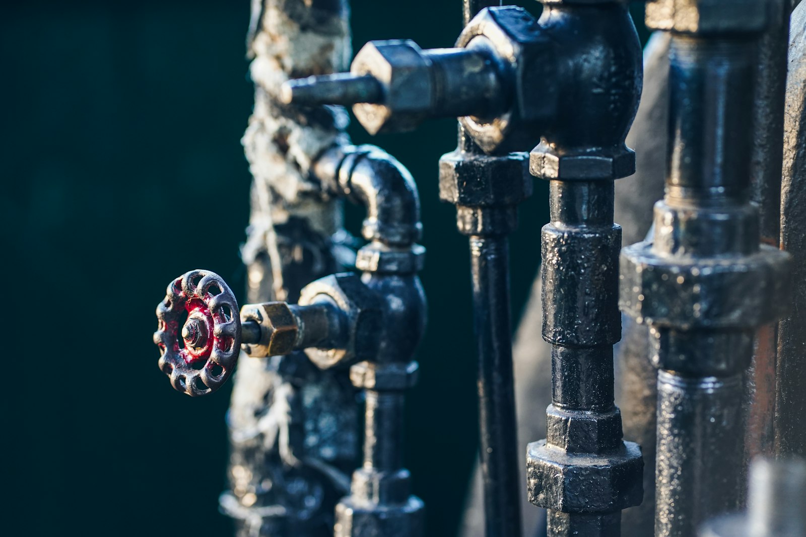 Blue pipework with a red valve wheel