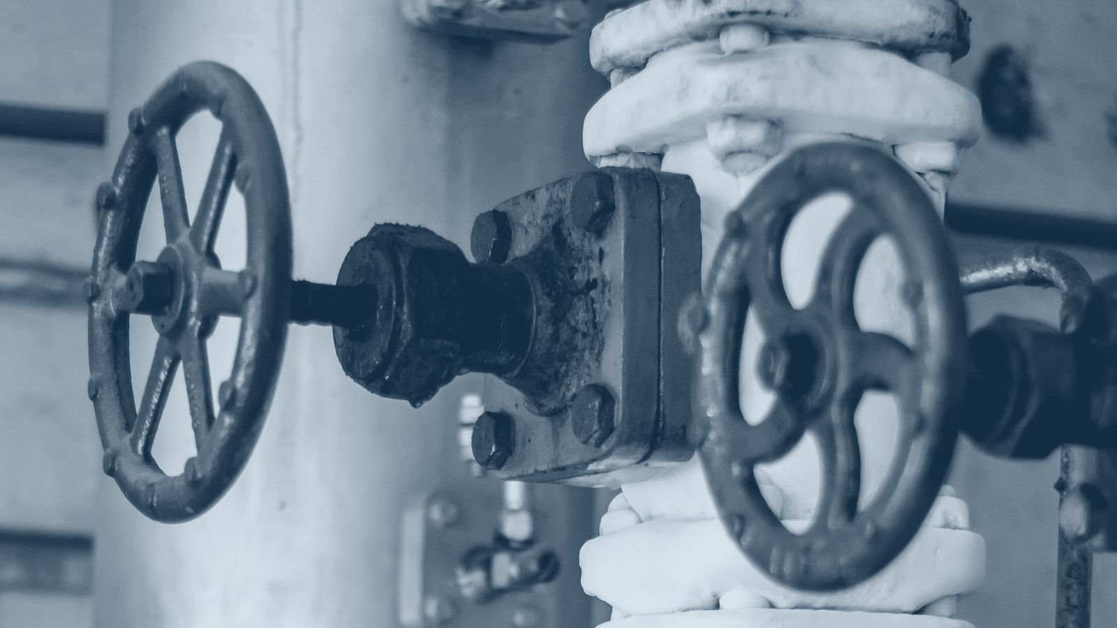 Frost covered refrigeration pipework and valves in a plant room