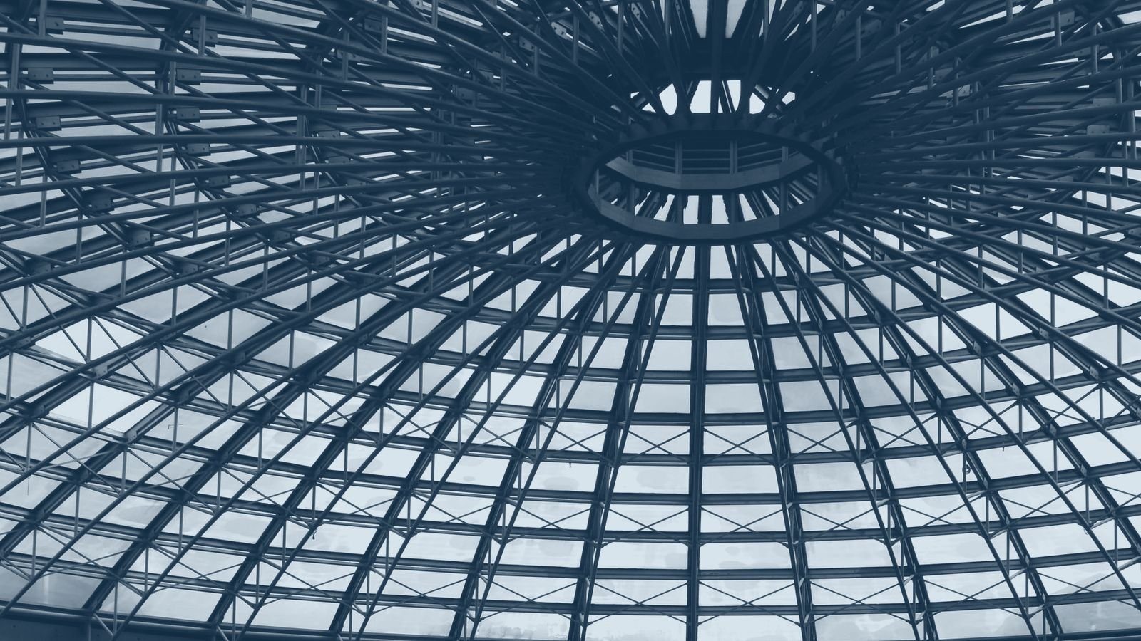 A shopping centre atrium under a glass dome